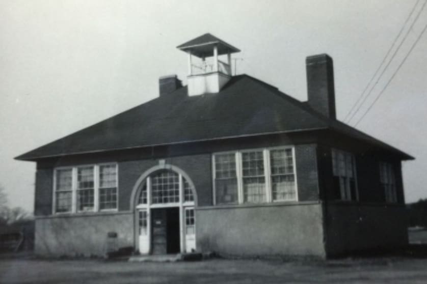 A black and white photo of an old school building.