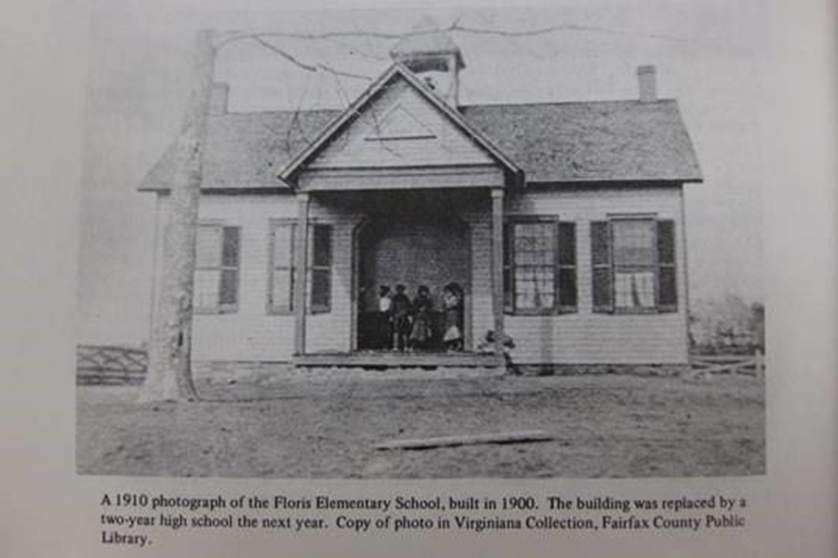 A black and white photo of the front of a school.