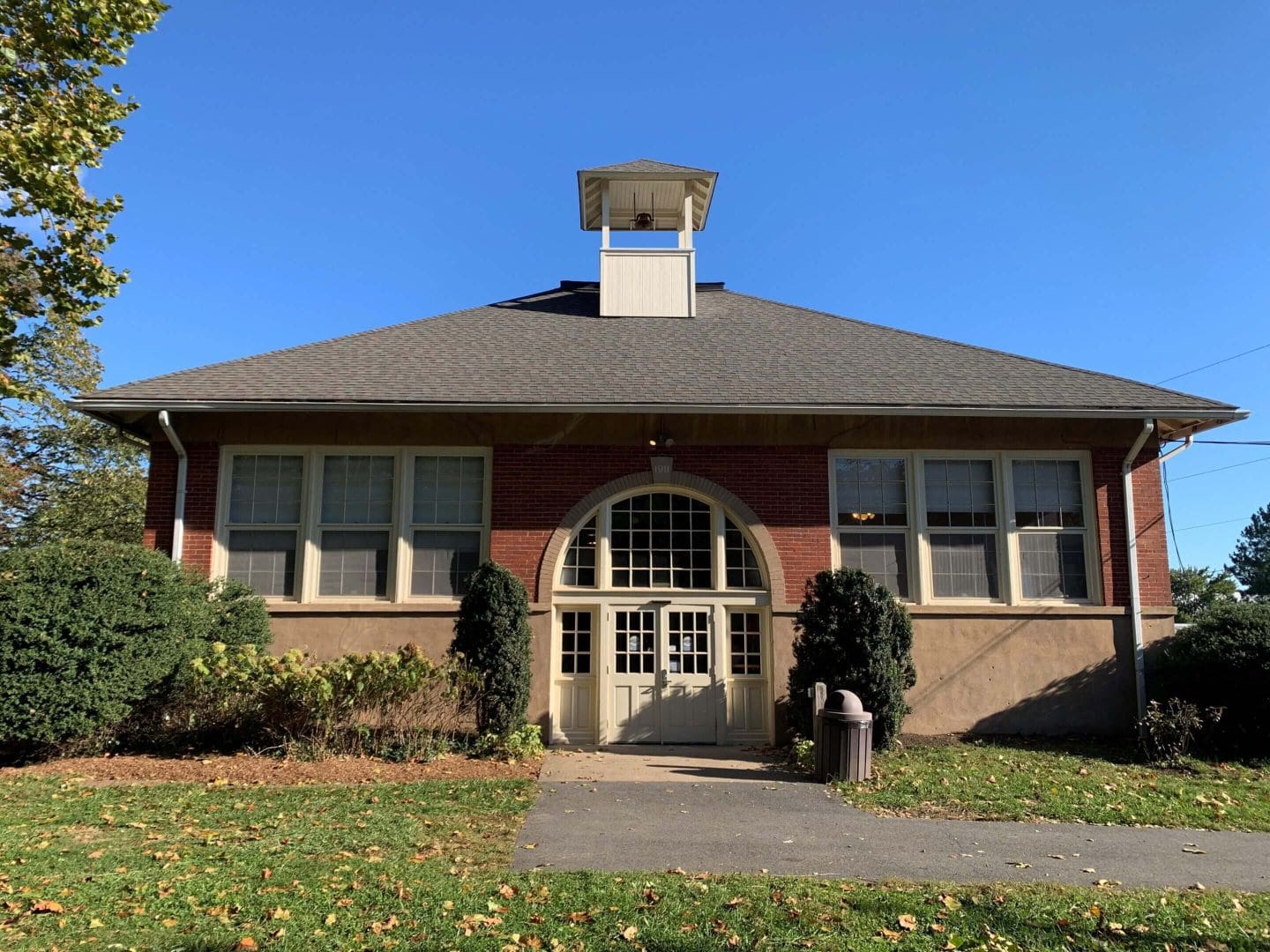 Brick schoolhouse with bell tower.